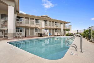 a swimming pool in front of a building at Days Inn by Wyndham Globe in Globe