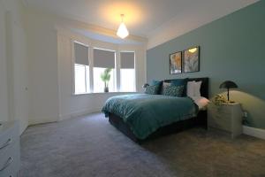 a bedroom with a bed and a window at Signature - St James House in Abbotsinch