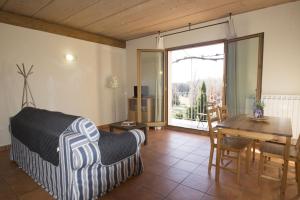 a bedroom with a bed and a table and a dining room at Cascina Cadorna 2 in Montegrino Valtravaglia