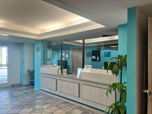 a bathroom with blue walls and a large mirror at Howard Johnson by Wyndham Clarksville Tennessee in Clarksville +39 photos