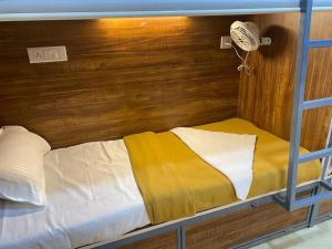a bunk bed in a room with a fan at Over True Dorms in Navi Mumbai
