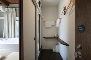 a small room with a bed and a hallway at hanare in Tokyo