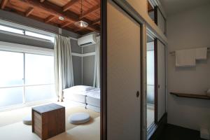 a small room with a bed and a window at hanare in Tokyo