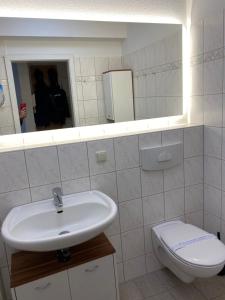 a bathroom with a sink and a toilet at Seestraße 70, Ap 30 in Zingst