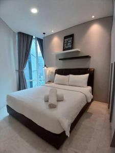 Ένα ή περισσότερα κρεβάτια σε δωμάτιο στο VORTEX SUITS KLCC by MMHB