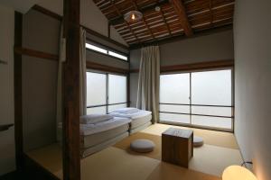 a bedroom with a bed and two windows at hanare in Tokyo