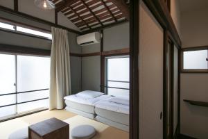 a room with a bed and two windows at hanare in Tokyo