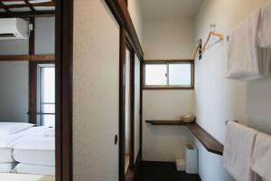 a small bathroom with a bed and a shower at hanare in Tokyo