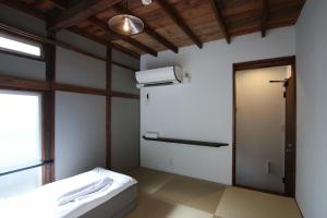 a room with a refrigerator and a door in it at hanare in Tokyo