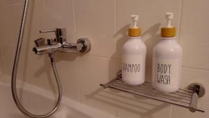 two bottles of soap on a shelf in a bathroom at The Beach House in Porto Rafti +36 photos