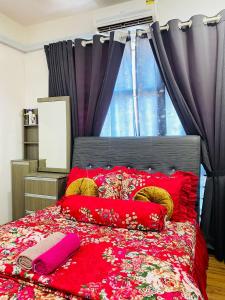 a bedroom with a red bed with red pillows at EM Suite Home 2Bedroom Dperdana Apartment in Kota Bharu +20 photos