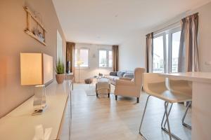 a living room with a couch and a table at FeWo Grosse Nr 6 in Kellenhusen
