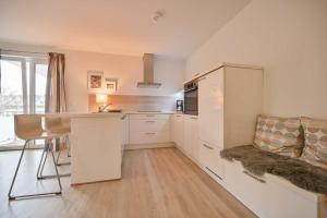 a kitchen with white cabinets and a counter top at FeWo Grosse Nr 6 in Kellenhusen