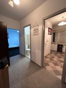 a room with a bathroom with a toilet and a doorway at Circumvalațiunii Studio in Timişoara