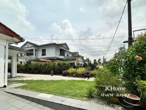 a large white house with a yard at Kempas Bungalow with KTV SwimmingPool in Johor Bahru