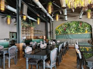 a dining room with tables and chairs and a large window at Roccia DownTown Otel in Van