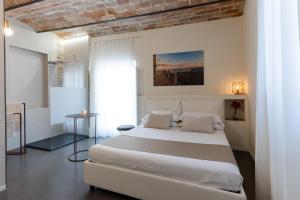 a bedroom with a large white bed in a room at Boutique Room Santa Maria by Il Timbro in Vasto
