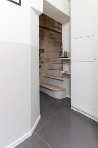 a hallway with white walls and a stone staircase at Boutique Room Santa Maria by Il Timbro in Vasto