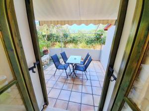 a view of a patio with a table and chairs at Alexaria Holidays Homes in Lefkada