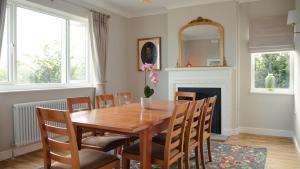 a dining room with a table and chairs and a fireplace at Bridge View Cottage in Cawood