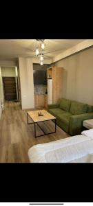a living room with a couch and a coffee table at tsaghkadzor apartment kechi house in Tsaghkadzor +6 photos