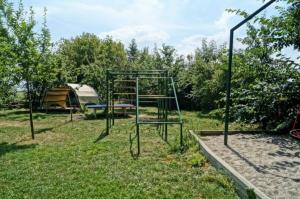 a swing set in the grass with a tent at Reethaus Mertinat For Six in Brandenhusen