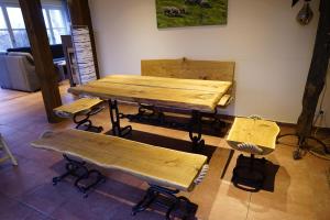a table and benches in a room with a table and chairs at Reethaus Mertinat For Six in Brandenhusen +10 photos