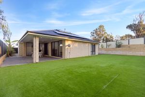 a house with a large lawn in front of it at The Happy Place in Dawesville