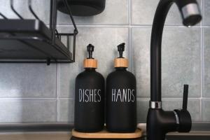 two black bottles sitting on top of a kitchen counter at Ca' La Stella Sea-view Apartments in Porto Azzurro