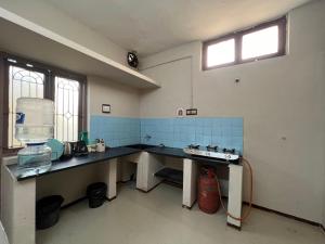 a kitchen with a counter and a sink in it at SHI's 2BHK home in Coimbatore near Sai Baba Colony, Ganga C Hospital, Women's care in Coimbatore