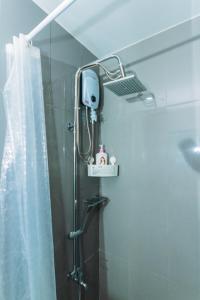a shower with a shower head in a bathroom at The Vibrant Condo Cool Stays 4254 Memorable Swim Gym Park Laugh in Manila