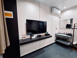 TV a/nebo společenská místnost v ubytování Yongjuxiang Mansion + 19 fotografií