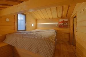 a bedroom in a log cabin with a bed in it at Tunturipöllö 2 in Ruka