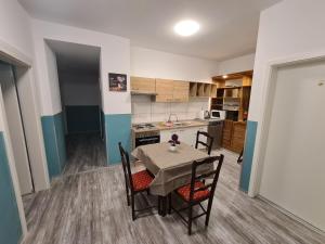 a kitchen and dining room with a table and chairs at Pension Anno 1866 in Plauen +3 photos