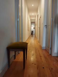 a hallway with a wooden floor and a bench in a room at Boho House Terrace in Porto