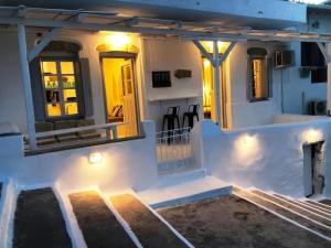a house with lights on the front of it at Milos Heritage Home 1883 in Adamantas