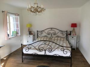 a bedroom with a bed and a chandelier at Kellerstöckl am veganen Bio-Lebenshof "Varm - die vegane Farm" in Bergla