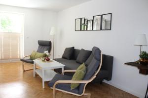 a living room with a couch and chairs and a table at Turmfalke in Bad Sülze