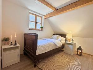 a bedroom with a large bed and a window at Kouzelná chalupa u lesa in Česká Lípa