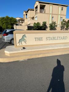 a shadow of a person standing in front of a sign at YA Eagle Wings Self Catering Shared Single room Apt B in Cape Town