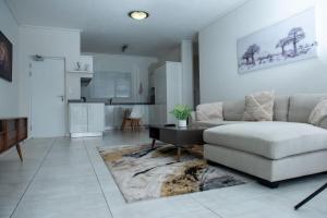 a living room with a couch and a table at Feelathome in Midrand