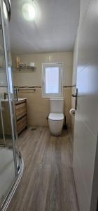 a small bathroom with a toilet and a window at Apartamento Magdalena II in Ferrol +18 photos