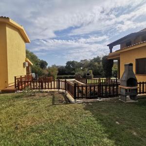 a wooden fence in front of a house at Villette Oasi in San Teodoro