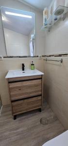 a bathroom with a sink and a mirror at Apartamento Magdalena II in Ferrol