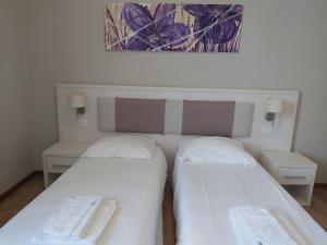 Postel nebo postele na pokoji v ubytování Lodges le Mura