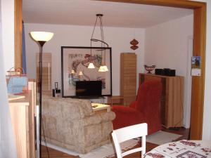 a living room with a couch and a chair at Dat Huuske in Gerdau