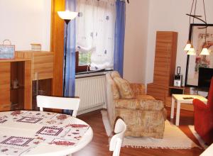 a living room with a chair and a table at Dat Huuske in Gerdau