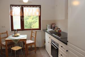 a kitchen with a table and a small table with chairs at Dat Huuske in Gerdau +7 photos