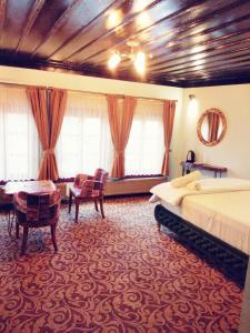 a hotel room with two beds and a table at Kayıbeyi Hotel & Restaurant in Bursa