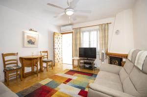 a living room with a couch and a table at Casa Vera in Torrevieja